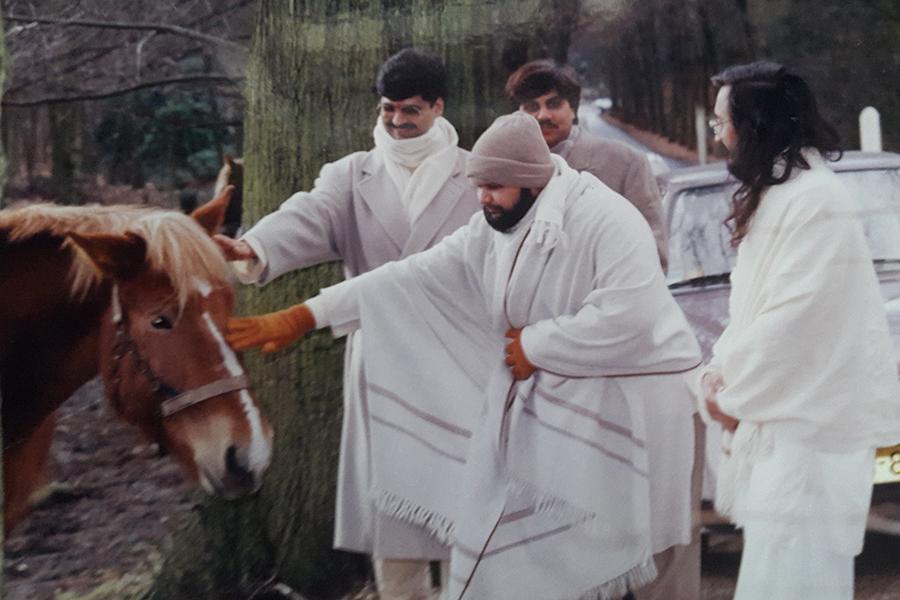 Brahmachari Girish Ji is playing with horse at forest near MERU, Holland, winter 1993